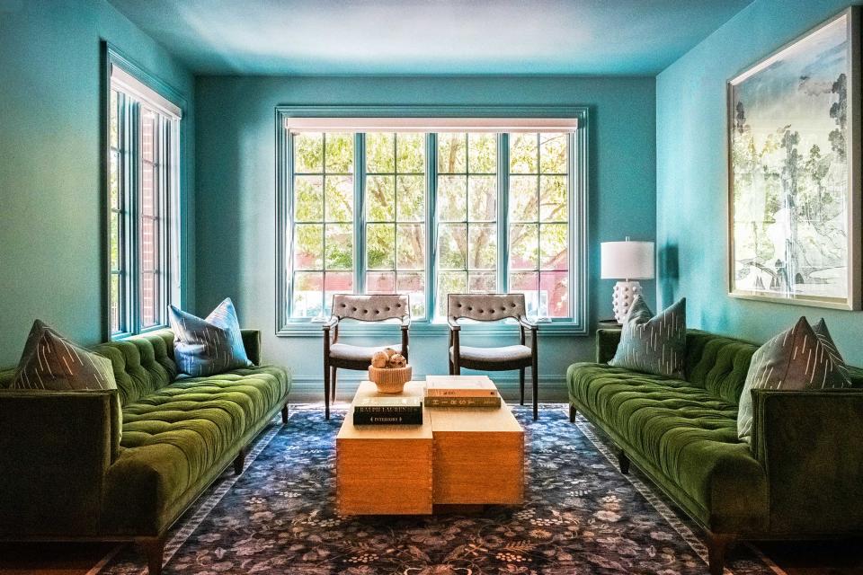 a blue living room with green sofa