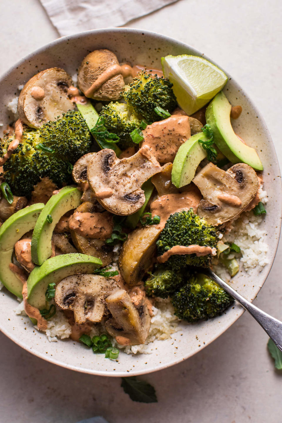 cauliflower rice topped with mushrooms, broccoli, and avocado