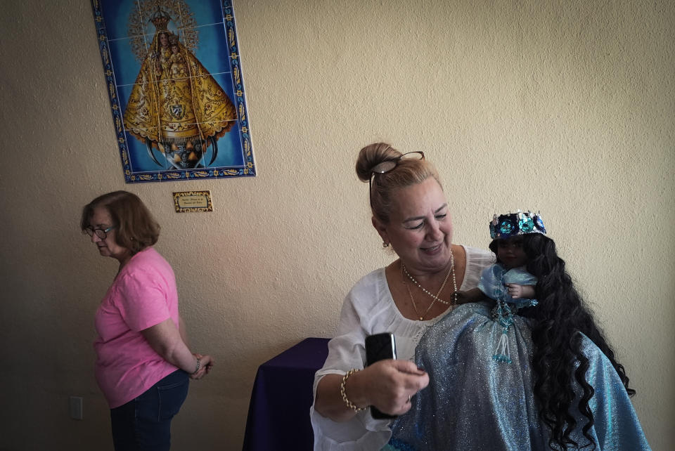 Barbara Ruiz holds her Yoruba religion’s deity "Yamaya," associated with The Virgin of Regla, at Our Lady of Charity shrine, known as La Ermita, during an Ash Wednesday Mass in Miami, Florida, Wednesday, Feb. 14, 2024. The Vatican-recognized Virgin of Charity, venerated by Catholics and followers of Afro-Cuban Santeria traditions, is at the heart of Cuban identity, uniting compatriots from the Communist-run Caribbean island to those who were exiled or emigrated to the U.S. (AP Photo/Marta Lavandier)