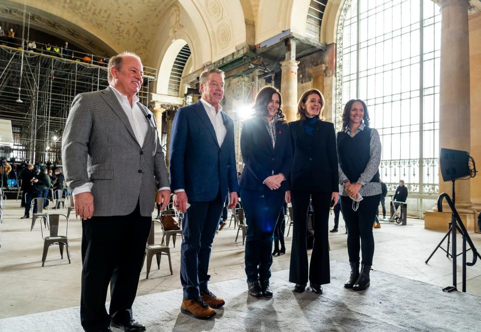 Detroit Mayor Mike Duggan, left, Ford Motor Co. Executive Chair Bill Ford, Michigan Gov. Gretchen Whitmer, Google and Alphabet CFO Ruth Porat and Detroit City Council President Mary Sheffield pose for a photo on stage before a presentation about the progress in the district and the building at Michigan Central Station in Detroit on Feb. 4, 2022.