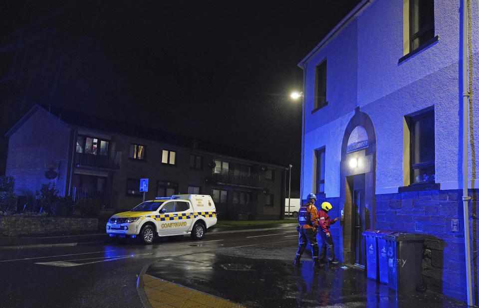 Emergency services in Stonehaven, Scotland, knock on doors and ask residents to evacuate due to flood warnings, Thursday, Oct. 19, 2023. Hundreds of people are being evacuated from their homes and schools have closed in parts of Scotland, as much of northern Europe braces for stormy weather, heavy rain and gale-force winds from the east. The U.K.’s weather forecaster, the Met Office, issued a rare red alert, the highest level of weather warning, for parts of Scotland. (Andrew Milligan/PA via AP)