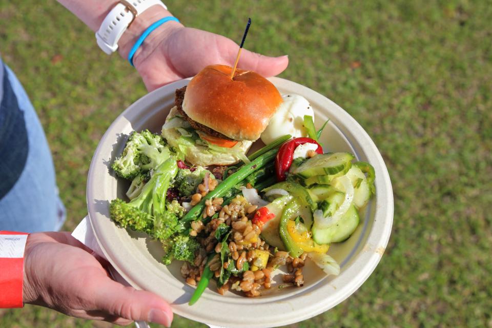 Jennifer Donaldson showing off her plate of food from the Forsyth Farmers' Market 15th anniversery Farm-R-Que on Sunday, April 28.