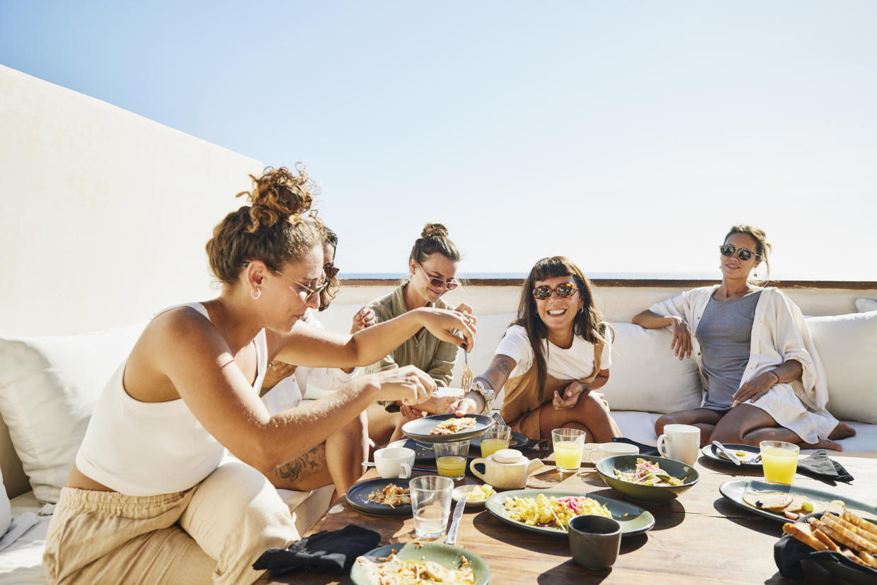 Group of friends eating on vacation.  (Getty Images)