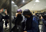 A reltive of one of the 47 pro-democracy activists reacts outside a court in Hong Kong Thursday, March 4, 2021. A Hong Kong court on Thursday remanded all 47 pro-democracy activists charged under a Beijing-imposed national security law in custody, ending a four-day marathon court hearing. (AP Photo/Vincent Yu)