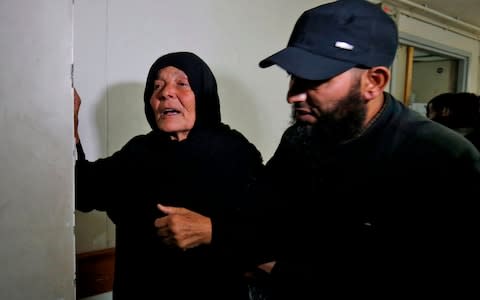 The mother of a commander for Hamas' armed wing who was killed during an Israeli operation on Khan Younis in the southern Gaza Strip, weeps at a hospital morgue where his body was transported - Credit: AFP