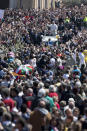 Pope Francis greets the faithful after celebrating an Easter Sunday Mass in St. Peter's Square at the Vatican Sunday, April 20, 2014. Cheering and applauding, the crowd tried to catch a glimpse of the pontiff as he circled around in his white popemobile at the end of the ceremony before he went to the central balcony over the basilica to deliver his commentary on the violence and poverty staining the Earth.(AP Photo/Andrew Medichini)