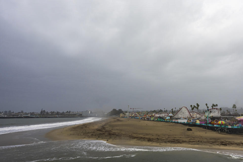 Storm clouds hang over the Santa Cruz Beach Boardwalk Wednesday, Jan. 31, 2024, in Santa Cruz, Calif. An atmospheric river is set to make its way into Northern California, bringing warnings of heavy rain, possible flooding and high winds. (AP Photo/Nic Coury)