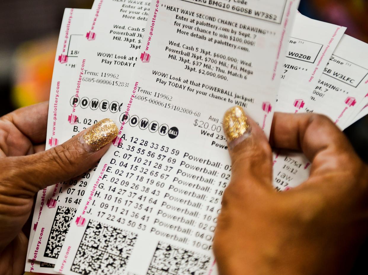 Doris Natal of Reading checks out her 126 Powerball tickets as part of a pool with the Berks County Sheriff's Office at the Sunoco in Exeter.