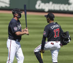 Atlanta Braves Hall of Famer Chipper Jones, left, gives infielder Johan Camargo some batting tips during spring baseball training Tuesday, Feb. 23, 2021, in North Port, Fla. (Curtis Compton/Atlanta Journal-Constitution via AP)