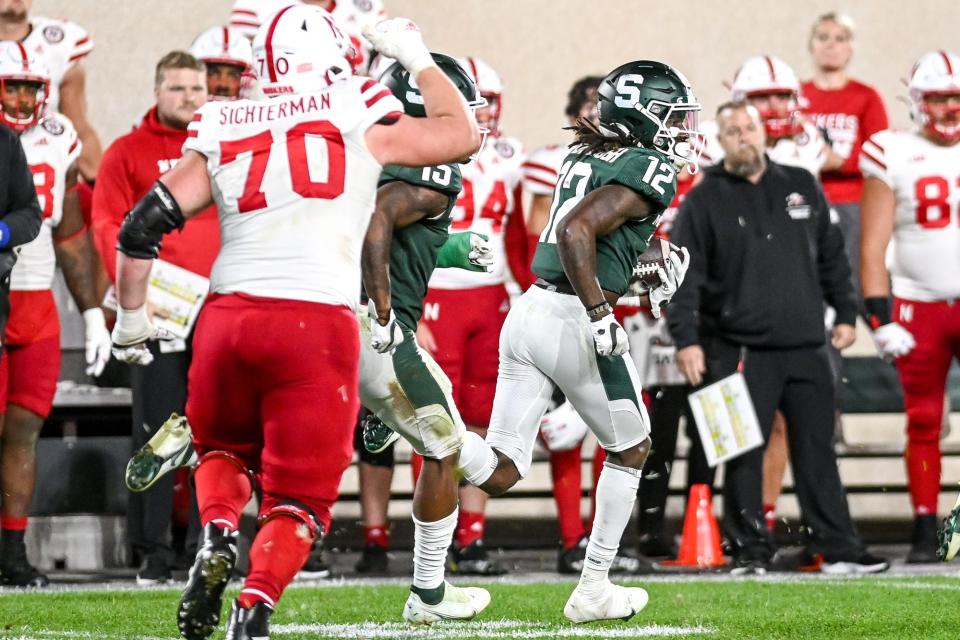 Michigan State's Chester Kimbrough, right, returns an interception against Nebraska during overtime on Saturday, Sept. 25, 2021, at Spartan Stadium in East Lansing.
