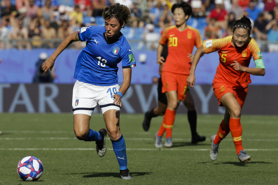 Italy's Valentina Giacinti, left, runs with the ball next to China defenders during the Women's World Cup round of 16 soccer match between Italy and China at Stade de la Mosson in Montpellier, France, Tuesday, June 25, 2019. (AP Photo/Claude Paris)