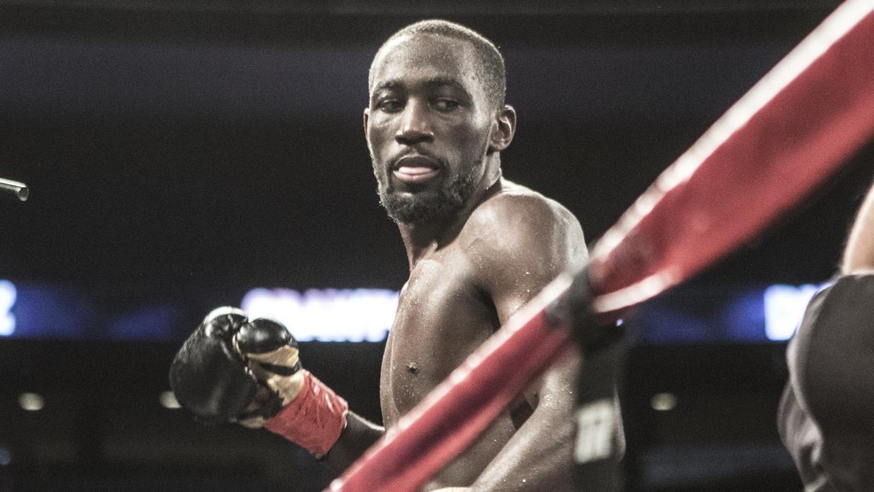  Super Lightweight boxer Terence Crawford holds his glove up in readiness for his opponent to strike back.  