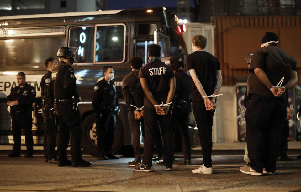 LOS ANGELES, CALIFORNIA - JUNE 02: Men are arrested after curfew went into effect during mostly peaceful demonstrations over George Floyd’s death downtown on June 2, 2020 in Los Angeles, California. Around 150 protestors were arrested in the area after the emergency 6:00 p.m. curfew took effect. California Governor Gavin Newsom has deployed National Guard troops to Los Angeles County to curb unrest which occurred amid some demonstrations. Former Minneapolis police officer Derek Chauvin was taken into custody for Floyd's death and charged with third-degree murder. (Photo by Mario Tama/Getty Images)