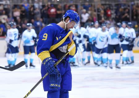 Sep 25, 2016; Toronto, Ontario, Canada; Team Sweden forward Filip Forsberg (9) wipes his face as he prepares to shake hands with Team Europe players celebrating a 3-2 overtime win during a semifinal game in the 2016 World Cup of Hockey at Air Canada Centre. Mandatory Credit: Dan Hamilton-USA TODAY Sports