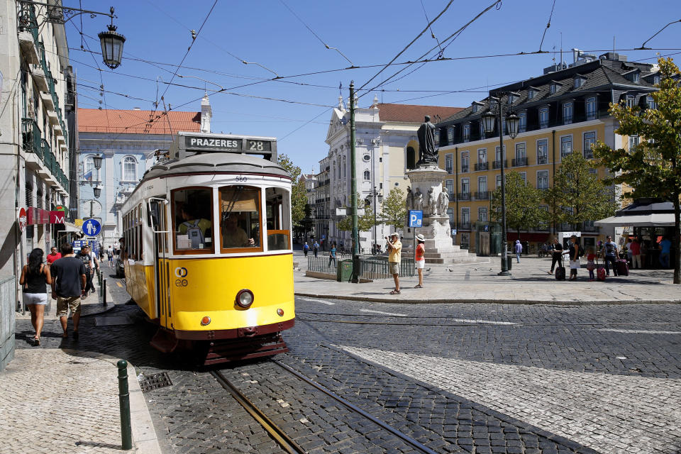 One of Lisbon's famous yellow trams, an attraction for the 4.5 million tourists who have been visiting the city each year. (Photo: Dominik Bindl via Getty Images)