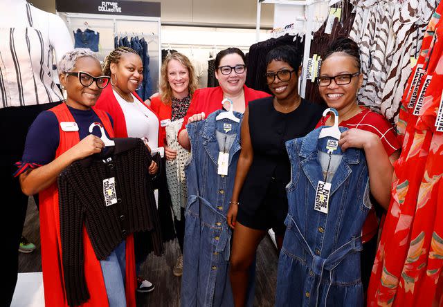 <p>Paul Morigi/Getty</p> Jenee Naylor poses with former Target team members celebrating her collection