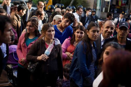 Kurdish people gather outside the Turkish embassy to vote in the parliamentary election in Tokyo, October 25, 2015. REUTERS/Thomas Peter