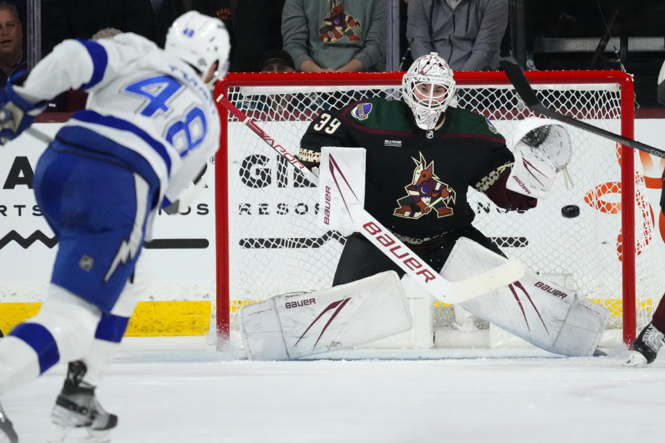 Arizona Coyotes goaltender Connor Ingram (39) reaches out to make a save on a shot by Tampa Bay Lightning defenseman Nick Perbix (48) during the first period of an NHL hockey game Tuesday, Nov. 28, 2023, in Tempe, Ariz. (AP Photo/Ross D. Franklin)