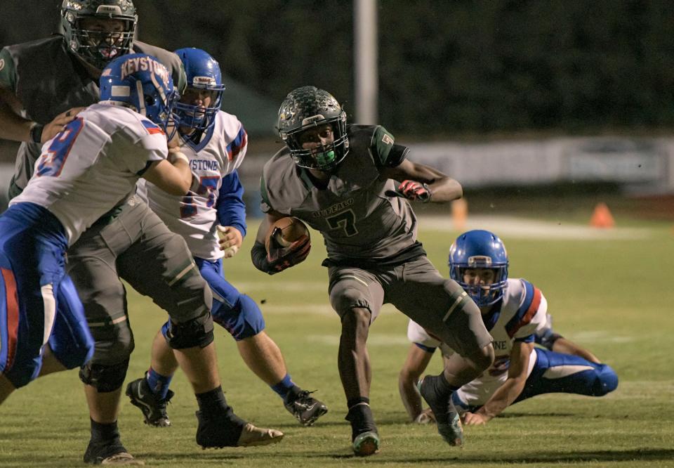 The Villages' Alvon Isaac (7) runs around the end at the Class 4A-Region 2 semifinal game on Nov. 19 against Keystone Heights at The Range in The Villages. [PAUL RYAN / CORRESPONDENT]