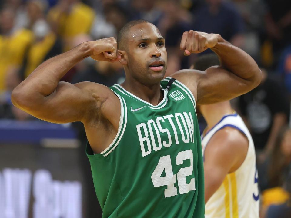 Al Horford flexes during a game in 2022.