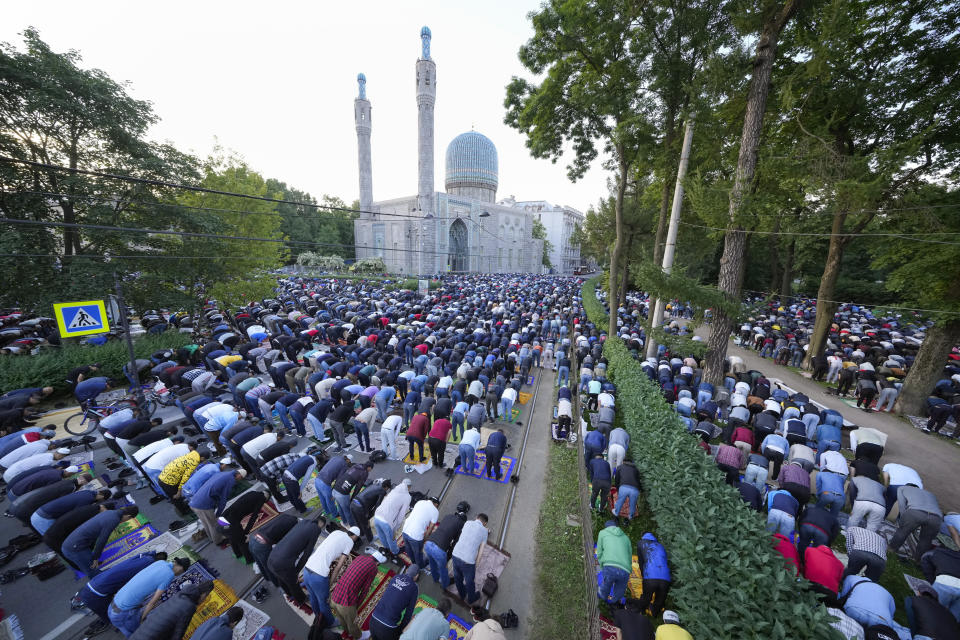 Muslims pray outside a mosque as they celebrate Eid al-Adha, which Muslims in Russia call Kurban-Bairam in St. Petersburg, Russia, early Saturday, July 9, 2022. The major Muslim holiday, at the end of the hajj pilgrimage to Mecca, is observed around the world by believers and commemorates prophet Abraham's pledge to sacrifice his son as an act of obedience to God. (AP Photo/Dmitri Lovetsky)