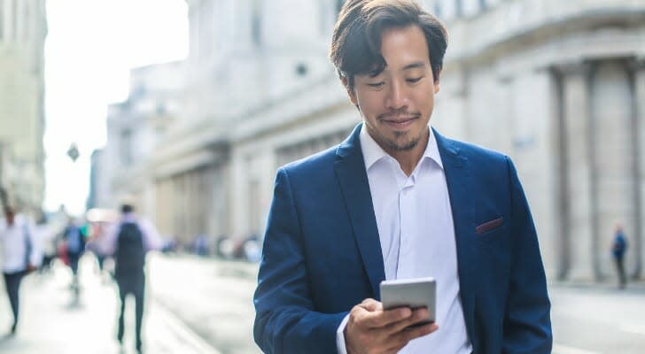 Man checks his investments on his mobile device