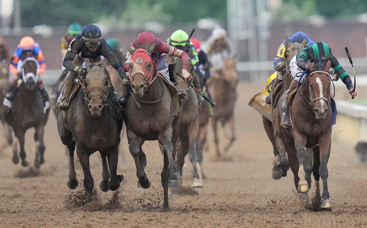 Jockey Tyler Gaffalione, left, on Sierra Leone pushes on Forever Young's jockey Ryusei Sakai after the two horses bumped and Mystik Dan with jockey Brian J. Hernandez, right, won the 2024 Kentucky Derby at Churchill Downs Saturday, May 4, 2024 in Louisville, Kentucky.