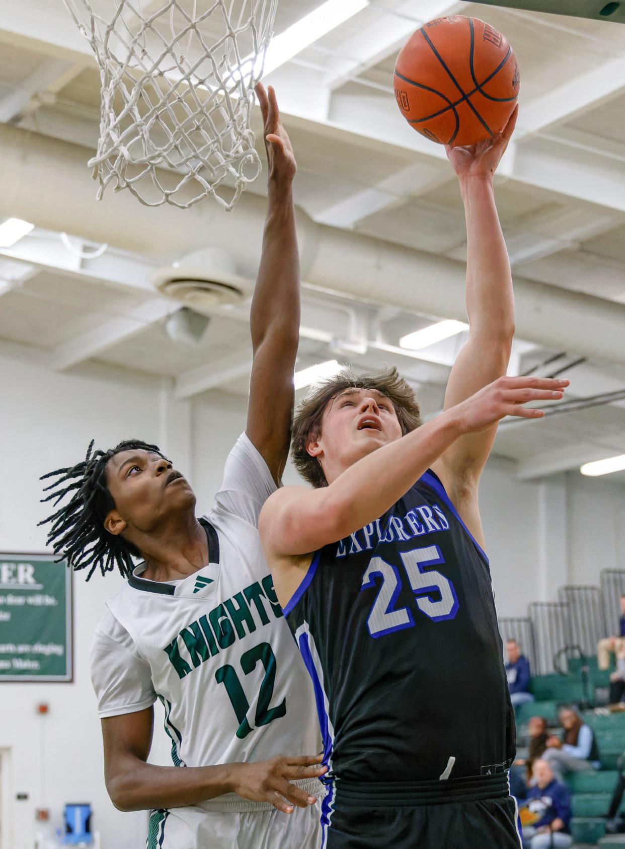 Hudson's Nathan Judy attacks the basket with Nordonia's CJ Caffey defending Tuesday, Jan. 23, 2024 in Macedonia.