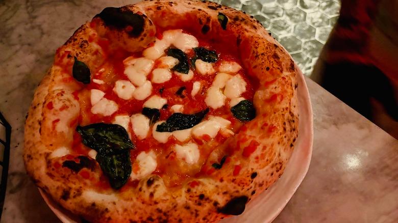 Cooked Margherita pizza on plate