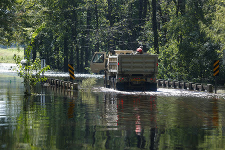 Members of the 1st Combat Engineer Company of the U.S. National Guard of Laurinburg, North Carolina, navigate flood waters in the aftermath of Hurricane Florence, now downgraded to a tropical depression, in Whiteville, North Carolina, U.S., September 18, 2018. REUTERS/Randall Hill