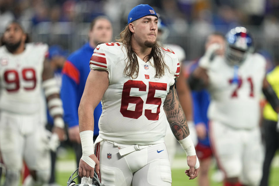 FILE - New York Giants center Nick Gates (65) walks off the field at halftime during an NFL wild-card football game against the Minnesota Vikings, Sunday, Jan. 15, 2023, in Minneapolis. A person with knowledge of the deal tells The Associated Press the Washington Commanders have agreed to terms with offensive lineman Nick Gates on a three-year contract. It cannot be signed until the new league year opens Wednesday, March 15. (AP Photo/Abbie Parr, File)