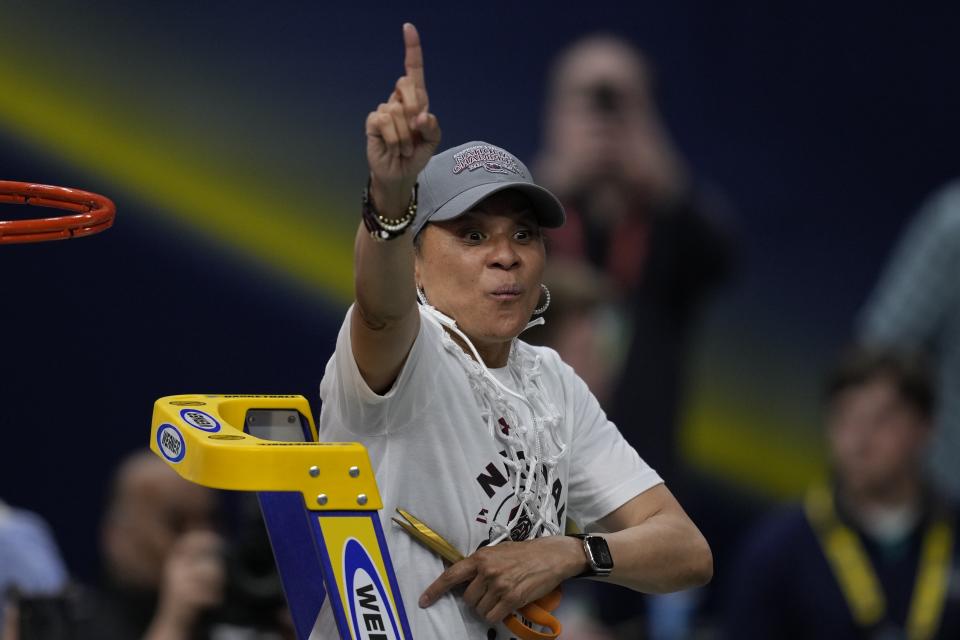 FILE - South Carolina head coach Dawn Staley cuts the net after a college basketball game in the final round of the Women's Final Four NCAA tournament against UConn Sunday, April 3, 2022, in Minneapolis. South Carolina won 64-49 to win the championship. (AP Photo/Charlie Neibergall, File)