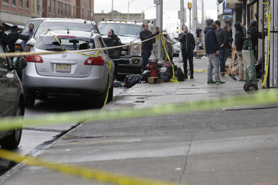 People work to secure the scene of a shooting at a kosher supermarket in Jersey City, N.J., Wednesday, Dec. 11, 2019. The mayor of a New Jersey city says gunmen targeted the kosher market during a shooting that killed six people Tuesday. (AP Photo/Seth Wenig)