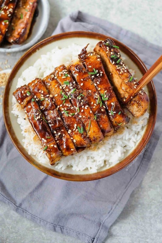 <p>The Foodie Takes Flight</p><p>An easy yet really tasty and satisfying maple hoisin tofu recipe! These slices of tofu are perfect enjoyed over a bowl of steamed rice or noodles.</p><p><strong>Get the recipe: <a href="https://thefoodietakesflight.com/maple-hoisin-tofu/" rel="nofollow noopener" target="_blank" data-ylk="slk:Maple Hoisin Tofu;elm:context_link;itc:0;sec:content-canvas" class="link "><em>Maple Hoisin Tofu</em></a></strong></p>
