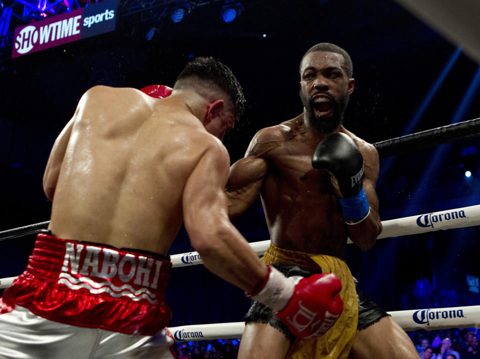 Gary Russell Jr., (R) battles Joseph Diaz Jr. during their WBC featherweight title fight in Oxon Hill, Md., Saturday, May 19, 2018. Russell won by unanimous decision. ( AP Photo/Jose Luis Magana)