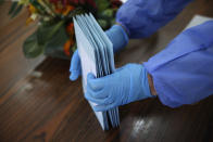 Municipal worker Mario Matos picks up sealed envelopes with presidential election ballot from residents at an elderly care home in Montijo, south of Lisbon, Tuesday, Jan. 19, 2021. For 48 hours from Tuesday, local council crews are collecting the votes from people in home quarantine and from residents of elderly care homes ahead of Sunday's presidential election. (AP Photo/Armando Franca)