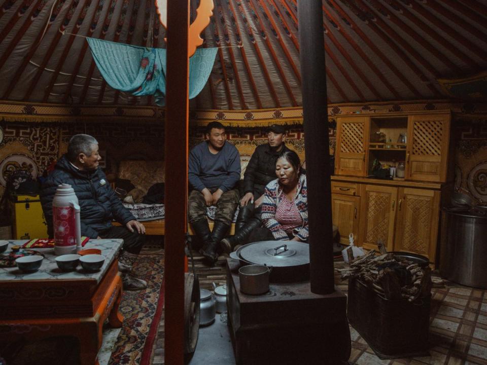 Sarangerel Tsetsegee, right, prepares boiled beef bones and millet broth for visitors in her ger nearby the Zuuvch-Ovoo mine. <span class="copyright">Nanna Heitmann—Magnum Photos for TIME</span>