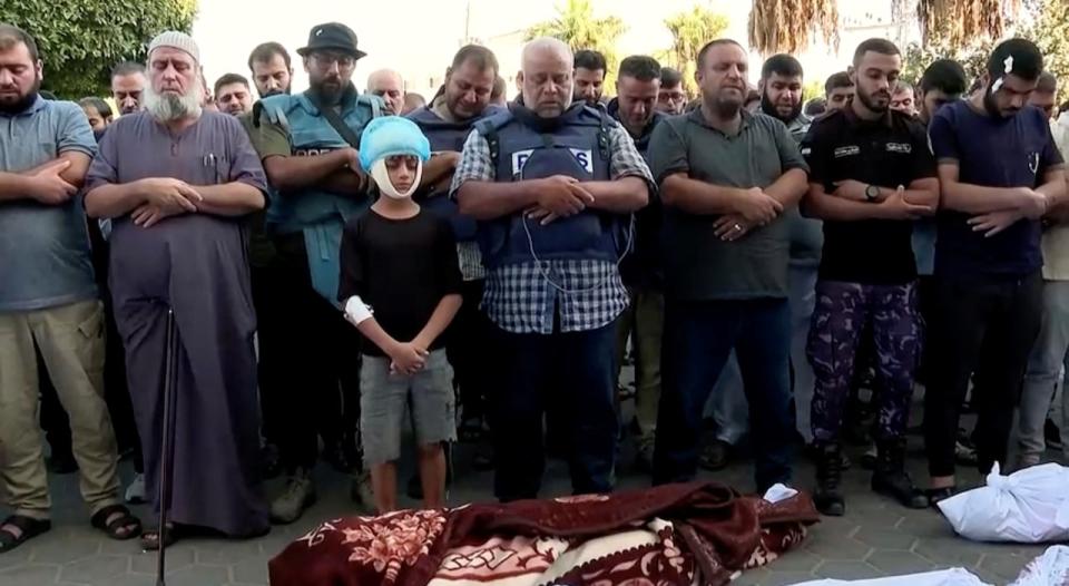 Al Jazeera correspondent, Wael Al-Dahdouh attends the funeral of his wife and children, who the network said were killed in an Israeli air strike, in central Gaza Strip, in this still image taken from a video obtained by Reuters on October 26, 2023. AL JAZEERA via REUTERS THIS IMAGE HAS BEEN SUPPLIED BY A THIRD PARTY.