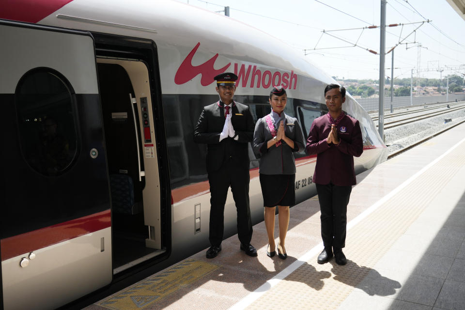 Officials stand near of high-speed railway during the opening ceremony for launching Southeast Asia's first high-speed railway at Padalarang station in Bandung, West Java, Indonesia, Monday, Oct. 2, 2023. Indonesian President Joko Widodo launched Southeast Asia's first high-speed railway that will start its commercial operations on Monday, a key project under China's Belt and Road infrastructure initiative that will cut travel time between two cities from the current three hours to about 40 minutes. (AP Photo/Achmad Ibrahim)