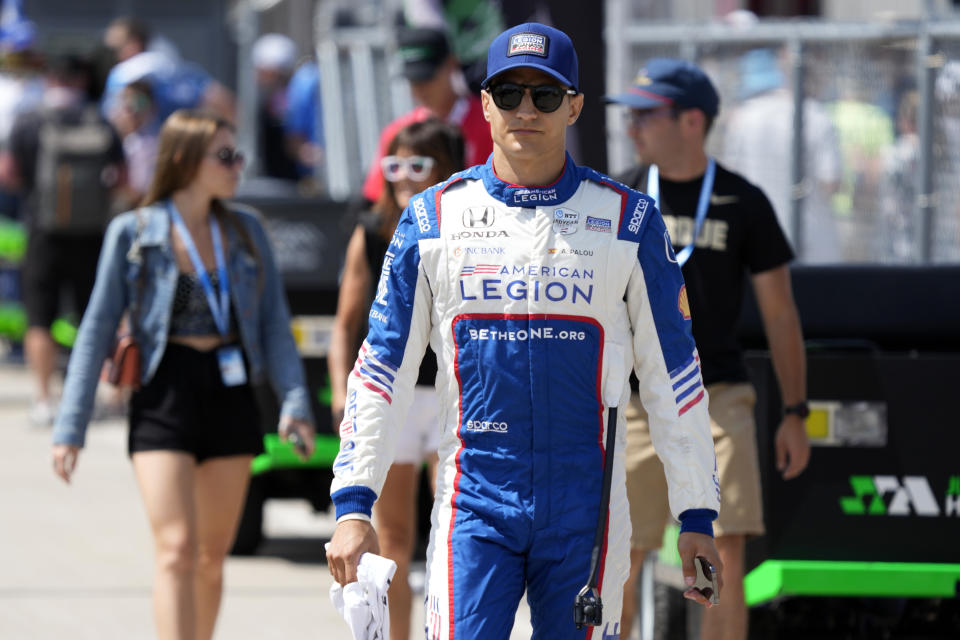Alex Palou, of Spain, walks in the pit area before practice for an IndyCar Series auto race, Friday, July 21, 2023, at Iowa Speedway in Newton, Iowa. (AP Photo/Charlie Neibergall)