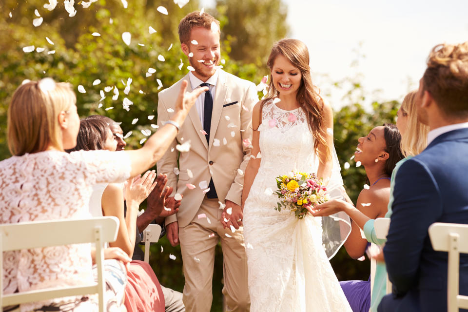 Bride and groom walk down aisle coronavirus wedding rule divides groups guests