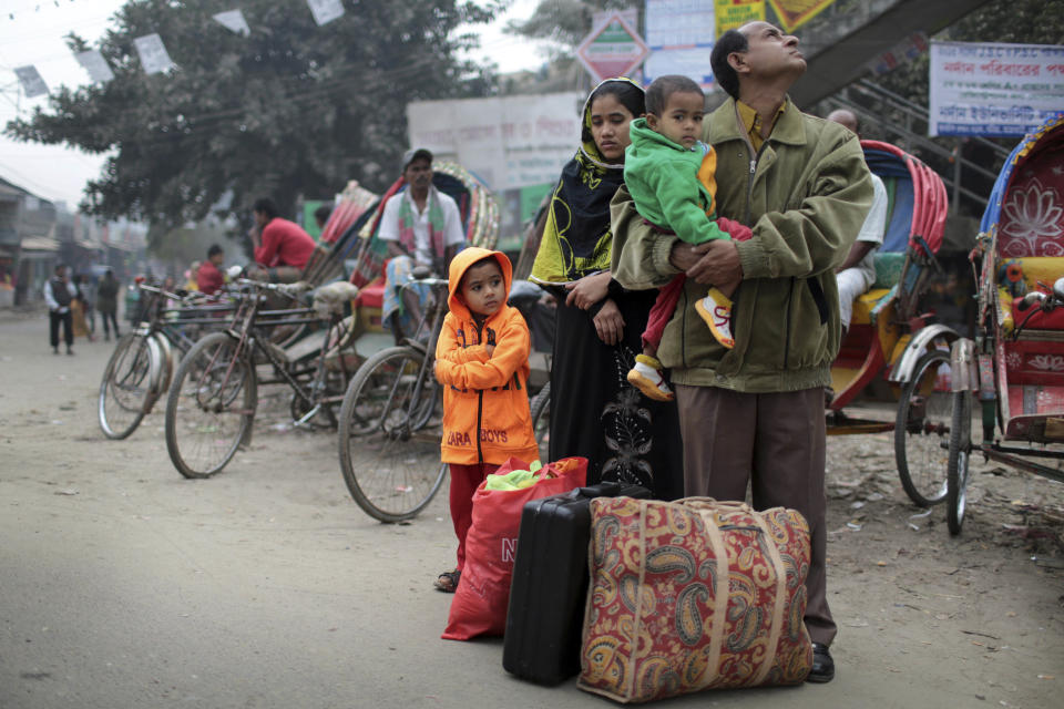 A Bangladeshi family waits for transportation during a 48-hours nationwide strike called by the main opposition Bangladesh Nationalist Party (BNP) against Sunday's general election, in Dhaka, Bangladesh, Monday, Jan. 6, 2014. Bangladesh's ruling Awami League won one of the most violent elections in the country's history, marred by street fighting, low turnout and a boycott by the opposition that made the results a foregone conclusion. (AP Photo/A.M. Ahad)