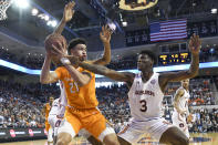 Tennessee forward Olivier Nkamhoua (21) looks for an open man over Auburn forward Danjel Purifoy (3) during the first half of an NCAA college basketball game Saturday, Feb. 22, 2020, in Auburn, Ala. (AP Photo/Julie Bennett)