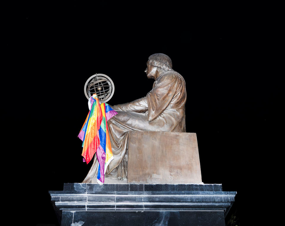 The Nicolaus Copernicus monument is decorated with a rainbow flag. | Rafal Milach—Magnum Photos