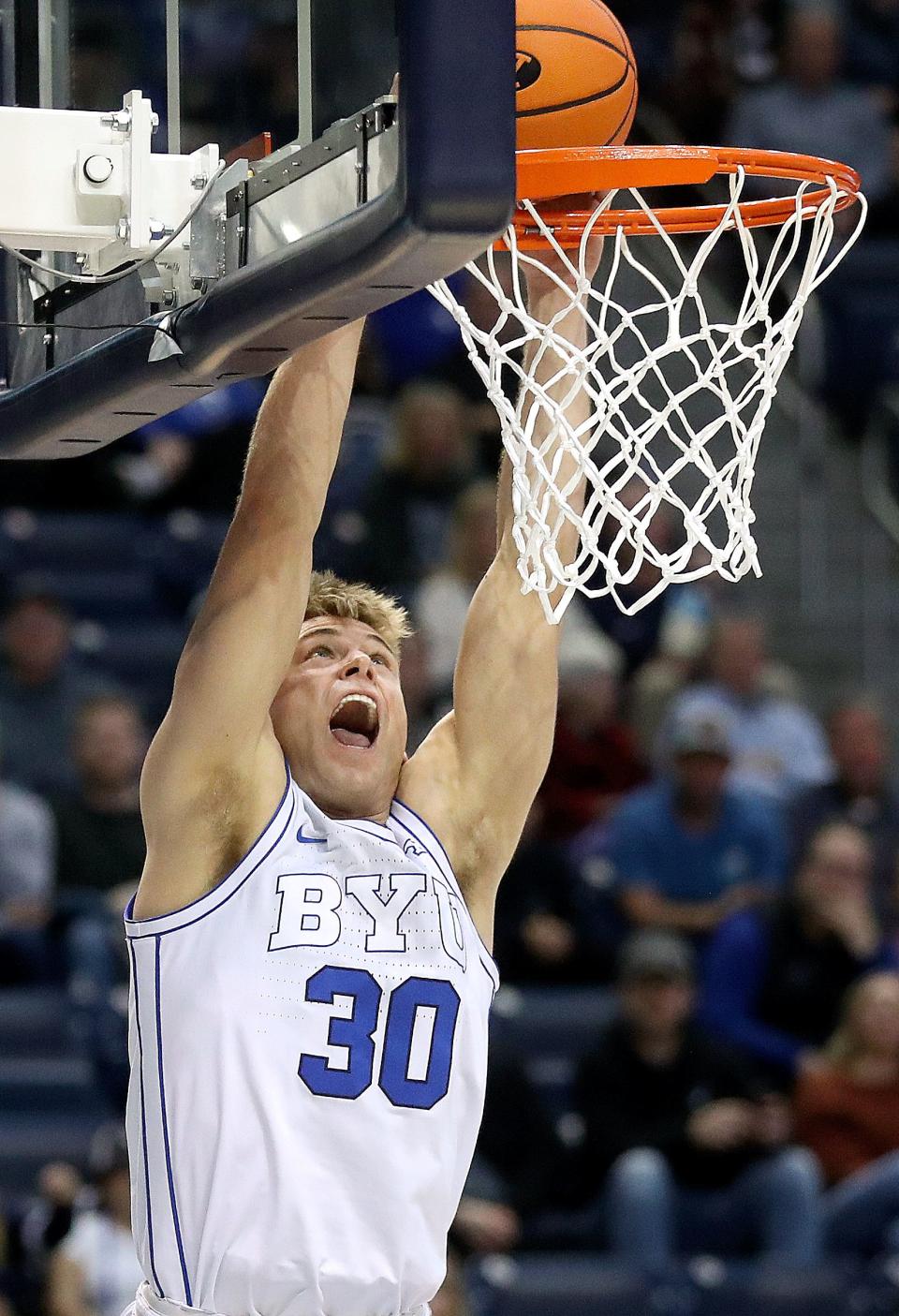 Brigham Young Cougars guard Dallin Hall (30) dunks the ball during a men’s basketball game against the Bellarmine Knights at the Marriott Center in Provo on Friday, Dec. 22, 2023. BYU won 101-59. | Kristin Murphy, Deseret News