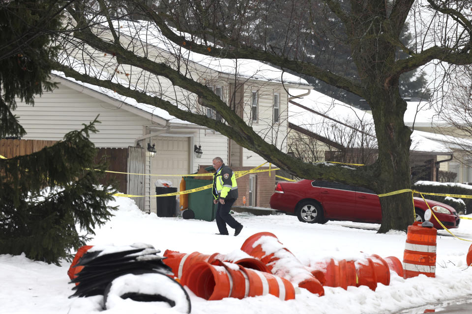 A Joliet police officer survey a crime scene , Tuesday, Jan. 23, 2024, to death. A man suspected of shooting and killing eight people in suburban Chicago fatally shot himself after a confrontation with law enforcement officials at a gas station in Texas, where he had no known ties, authorities said. (Antonio Perez /Chicago Tribune via AP)