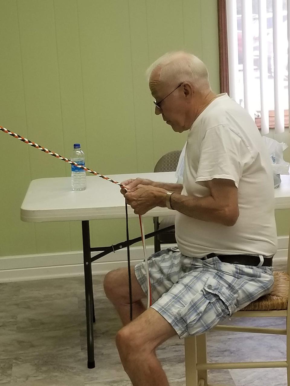 Gary Miller demonstrates his special braiding skills in producing recycled jump ropes at last year's Operation Christmas Child workshop held at St. Paul's Lutheran Church of Colon. His jump ropes are just one of the many handmade crafts, toys and articles of clothing made at the annual workshops.