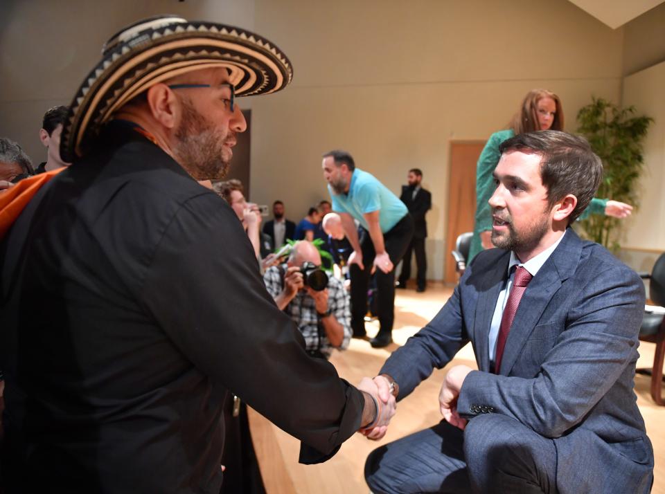 New College of Florida Assistant Professor of Theater and Performing Studies Diego Villada, left, shakes hands with recently appointed trustee of New College of Florida, Christopher Rufo following a meeting with faculty and staff and two new trustees, Rufo, and Jason "Eddie" Speir on Wednesday in Sarasota. 