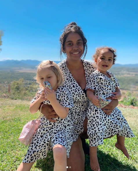 Michelle Ludwig with her two toddle daughters at their hilltop home in Yeppoon. 