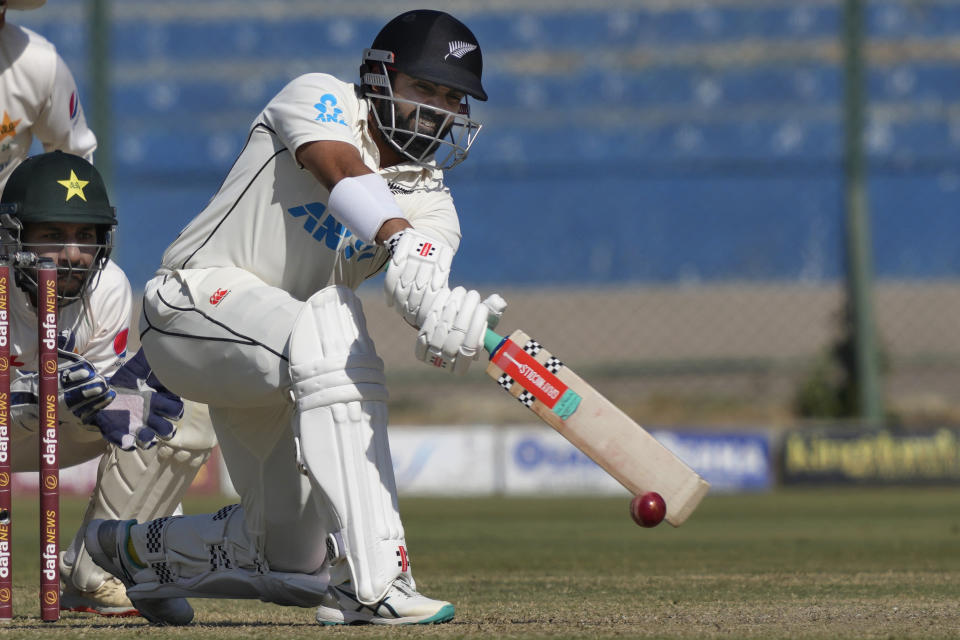 New Zealand's Ajaz Patel, center, plays a shot as Pakistan's Sarfraz Ahmed watches during the second day of the second test cricket match between Pakistan and New Zealand, in Karachi, Pakistan, Tuesday, Jan. 3, 2023. (AP Photo/Fareed Khan)